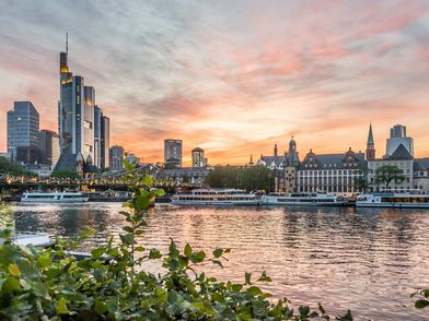 Sunset with evening red sky over the Main and Frankfurt skyline.
